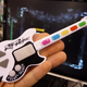 Illustration for article titled CES 09: The Worlds Tiniest Video Game Guitar Controller